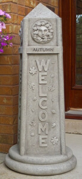 stone obelisk features intricate carvings representing the four seasons: spring, summer, winter, and autumn